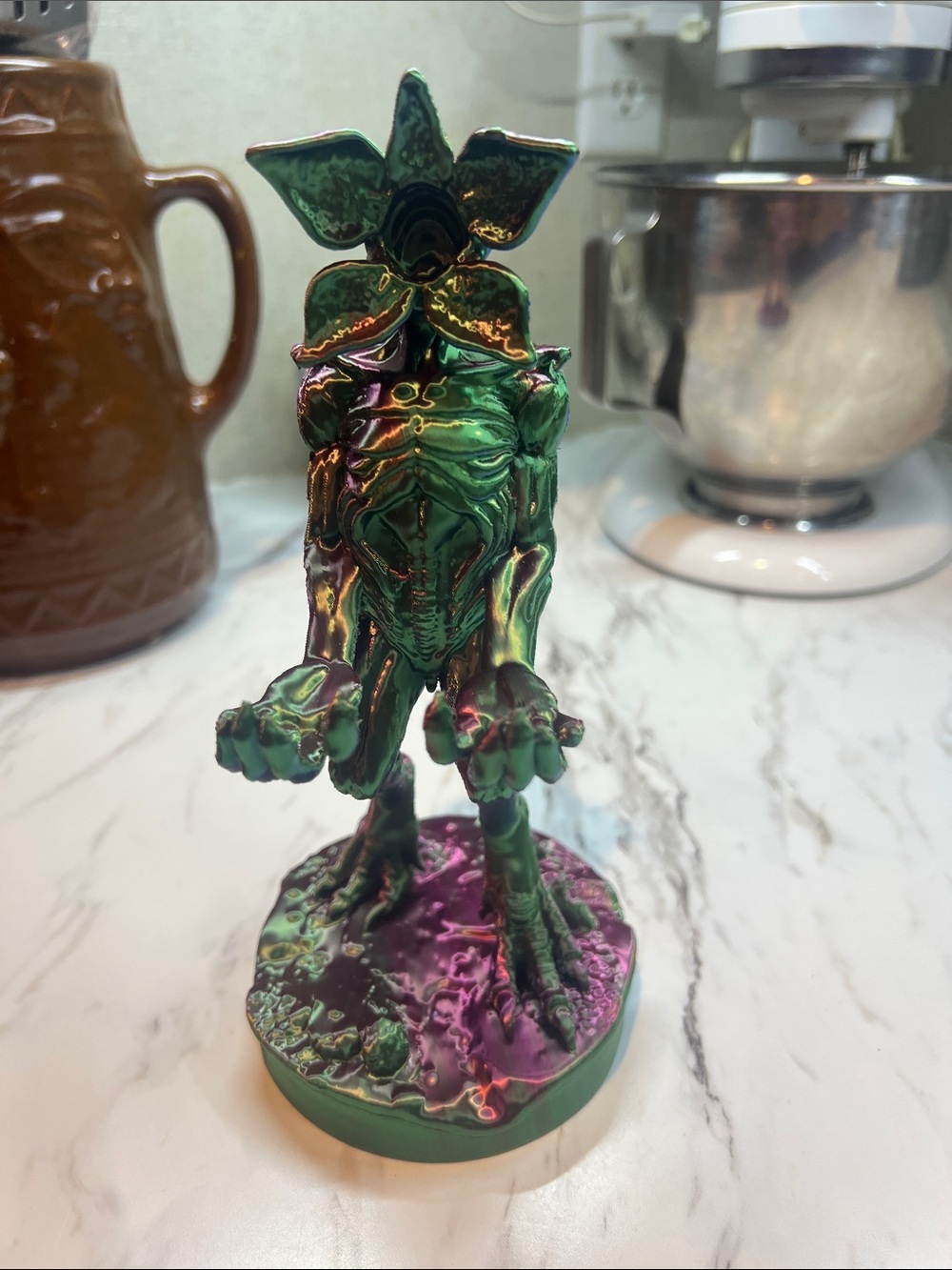 Green Iridescent Stranger Creature Figurine phone holder. 3dprinted
